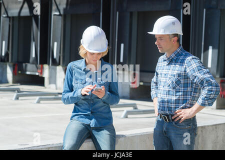 I supervisori in attesa di carrello di entrare nel cantiere di spedizione Foto Stock