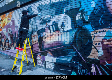 Pittura murale in corso, raffiguranti i cento anni di storia di Vancouver, DTES, Gastown, Vancouver, British Columbia, Canada. Foto Stock