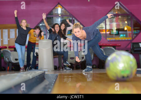 Amici divertendosi mentre bowling e trascorrere del tempo insieme Foto Stock