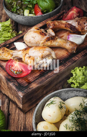 Pollo arrosto gambe su di una cucina elegante bordo Foto Stock