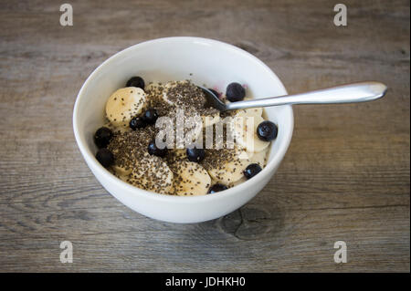 Ciotola di porridge con banana, chia semi e mirtilli Foto Stock