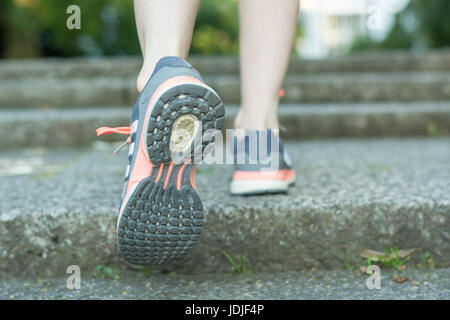 Fare le scale di corsa con le scarpe running close up da dietro Foto Stock