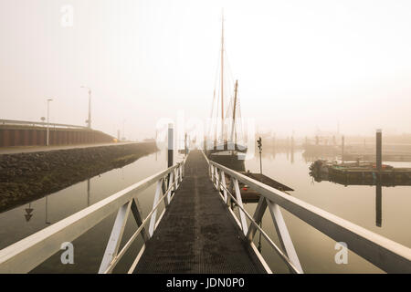 Barche da pesca in attesa di partenza ritardata nel porto di Bruinisse, Zeeland, a causa di una pesante velatura durante il sunrise. Acqua calma e un tranquillo scenario wit Foto Stock