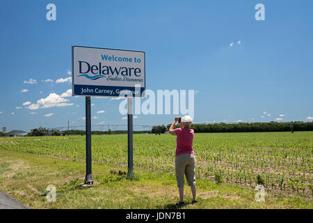 Atlanta, Delaware - un turista scatta una foto di un benvenuto a Delaware segno accanto a un campo di mais nella parte sud-occidentale dello stato. Foto Stock