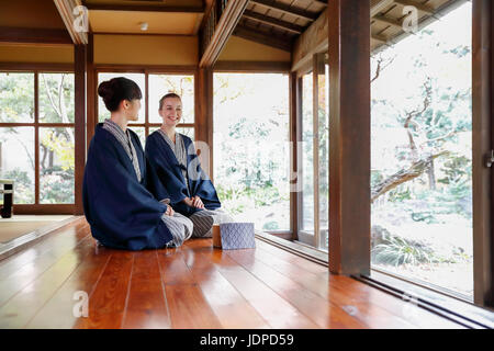 La donna caucasica indossare uno yukata Giapponesi con amico al ryokan tradizionale, Tokyo, Giappone Foto Stock