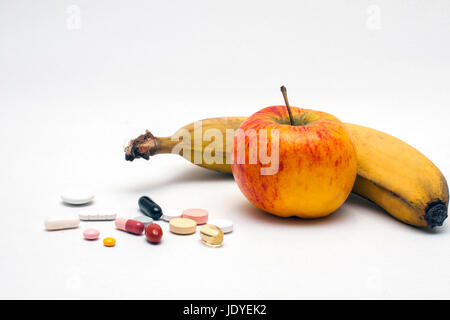Verschiedene Tabletten bunte, Apfel und Banane, isoliert Foto Stock