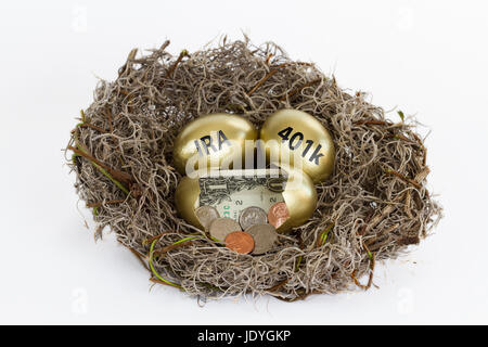Nido pieno di uova d'oro con un uovo aperto contenente denaro contante e due uova etichettati 401k & IRA. Foto Stock