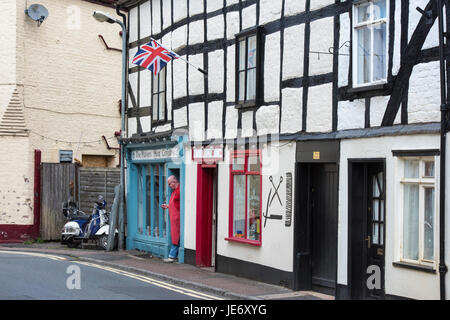 Union Jack Flag, scooter e negoziante in court street. Upton-su-Severn, Worcestershire, Inghilterra Foto Stock