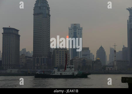 Questa immagine cattura una splendida vista del tramonto sul Bund di Shanghai, Cina. Il Bund è un'area storica di fronte al mare conosciuta per la sua architettura di epoca coloniale e lo skyline moderno, che offre una combinazione unica di vecchio e nuovo. Foto Stock