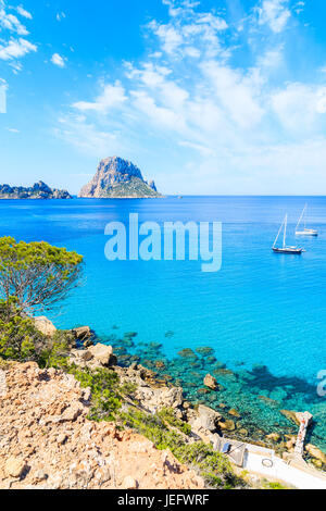 Vista di Cala d'Hort bay con belle blu mare azzurro acqua e Es Vedra island in distanza, isola di Ibiza, Spagna Foto Stock