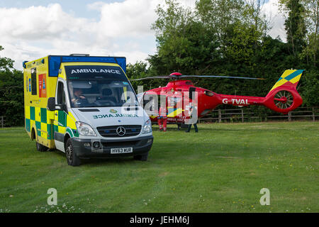 La Thames Valley Air Ambulance terre in un campo di Oxfordshire prima di trasportare un malato gravemente ferito in ospedale. Foto Stock