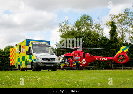 La Thames Valley Air Ambulance terre in un campo di Oxfordshire prima di trasportare un malato gravemente ferito in ospedale. Foto Stock