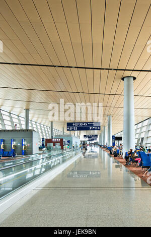 KUNMING-14 LUGLIO 2014. Interni spaziosi dell'Aeroporto Internazionale di Kunming Changshui con viaggiatori che camminano intorno. Foto Stock