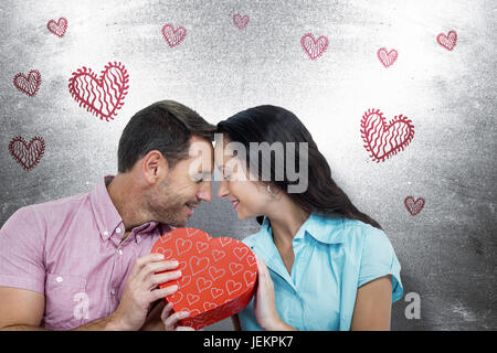 Immagine composita della coppia felice con il cuore Foto Stock