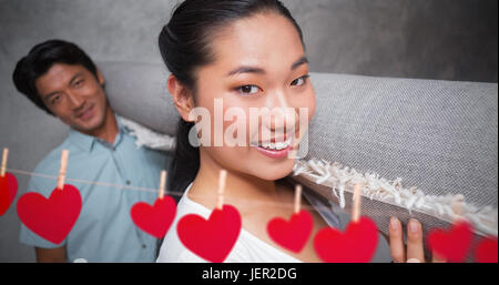 Immagine composita di cuori appesi su una linea Foto Stock