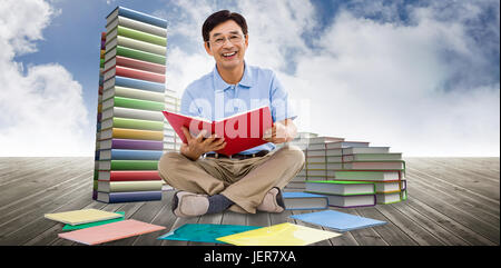 Immagine composita di uomo sorridente la lettura di libri Foto Stock