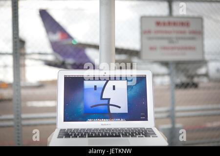 Per ragioni di sicurezza cabina portatili sono vietati su determinati voli: notebook Apple che mostra una faccina triste in un recinto all'Aeroporto Internazionale di San Diego, nel marzo 2017. | Utilizzo di tutto il mondo Foto Stock