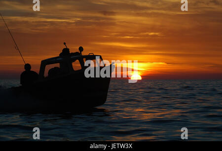 Piccola barca da pesca torna a casa dal tramonto pesce in Cornwall Regno Unito Foto Stock