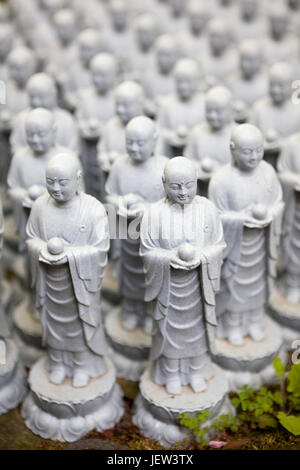 KAMAKURA, Giappone - CIRCA APR, 2013: vista ravvicinata a migliaia di piccoli Jizo sassoso statue stand in lunghe file nei pressi di Jizo-fare Hall di Hasedera. Il statu Foto Stock