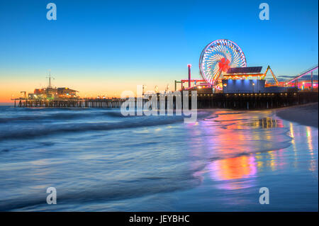 L'iconico Santa Monica Pier e spiaggia fotografato dopo il tramonto dal muscolo originale spiaggia di Santa Monica, CA. Foto Stock