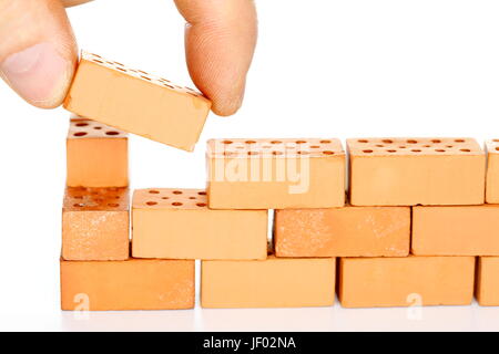 La costruzione di un muro di mattoni Foto Stock