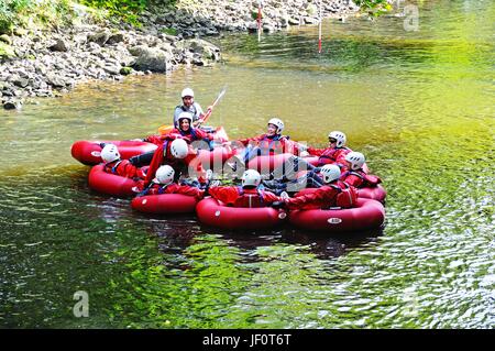 Un gruppo di persone in canoe di gomma in un cerchio lungo il fiume Derwent, Matlock Bath, Derbyshire, Inghilterra, Regno Unito, Europa occidentale. Foto Stock