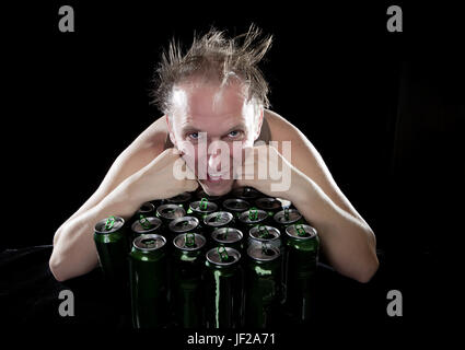 La felice ubriaco uomo vicino a vuoto vasi di birra Foto Stock