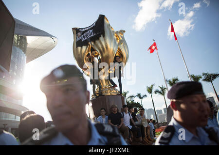 Hong Kong, Hong Kong. Il 28 giugno, 2017. I dimostranti la salita ad una golden bauhinia scultura su Giugno 28, 2017 a Wan Chai District di Hong Kong prima della prossima visita del Presidente cinese Xi Jinping per il ventesimo anniversario della Hong Kong ritorno alla Cina. Credito: Chan Hei Long/Pacific Press/Alamy Live News Foto Stock