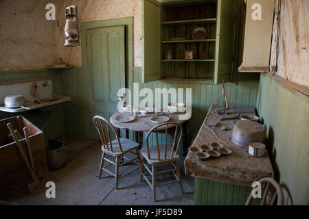 Una cucina con un eat-in sala da pranzo in una casa abbandonata in Bodie Ghost Town. Foto Stock