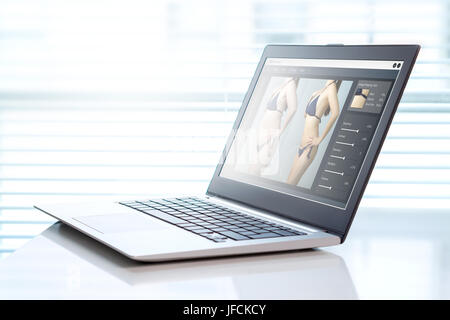 Software di editing fotografico in un notebook in ufficio. Trasformando la ragazza più sottili e slim per la commercializzazione o la pubblicità. Gli standard di bellezza concetto. Foto Stock