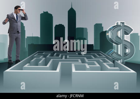Uomo che cerca di raggiungere dollari attraverso il labirinto Foto Stock