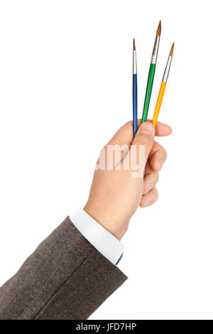Mano con pennelli multicolore Foto Stock