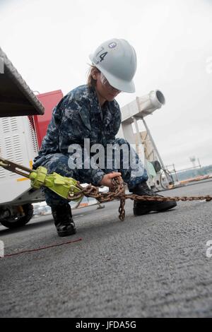 170628-N-TU932-016 BREMERTON, Washington (28 giugno 2017) dell'aviazione Equipaggiamento di supporto tecnico Airman Carly Smith, da Shipman, Illinois, fissa un P25 Trattore di estinzione a USS John C. Stennis' (CVN 74) ponte di volo. John C. Stennis sta conducendo una prevista disponibilità incrementale (PIA) a Puget Sound Naval Shipyard e Manutenzione intermedia Facility, durante il quale la nave sta subendo una manutenzione pianificata e aggiornamenti. (U.S. Foto di Marina di Massa lo specialista di comunicazione di terza classe Sierra D. Langdon / rilasciato) Foto Stock