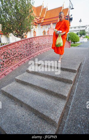 Thailandia, Bangkok, Wat Benchamabophit aka il tempio in marmo, monaci Camminando sul ponte ad arco Foto Stock