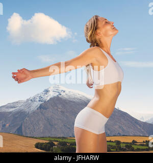 Immagine composita della splendida bionda montare in piedi con le braccia Foto Stock