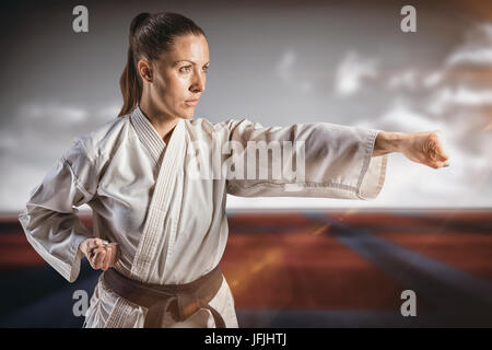 Immagine composita del combattente donna eseguendo il karate posizione Foto Stock