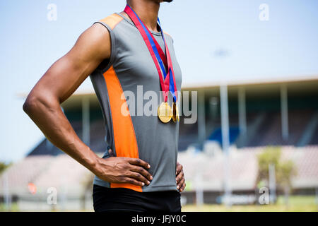 Atleta in posa con medaglie d oro intorno al suo collo Foto Stock