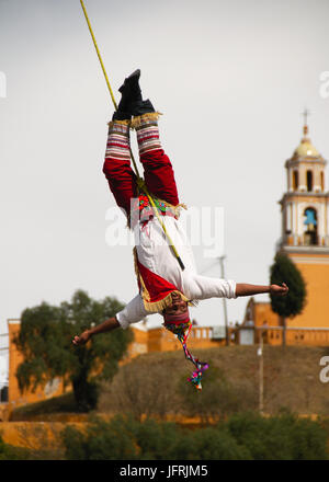 CHOLULA, PUEBLA, Messico - 2012: un membro degli acrobati noto come 'los voladores' esegue davanti alla Grande Piramide di Cholula. Foto Stock