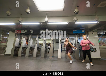 I passeggeri per sfogliare i tornelli nel restaurato di recente a sud del traghetto la stazione della metropolitana di New York sulla riapertura giorno Martedì, 27 giugno 2017. La stazione restaurata è stata chiusa dopo un danno catastrofico da Superstorm sabbiose con una stima di 15 milioni di galloni di acqua di inondazione del terminale che al costo di $ 545 milioni di euro ed è stato aperto solo tre anni. Il $340 milioni per le riparazioni sono stati finiti oggi quasi cinque anni dopo Superstorm Sandy. Nel frattempo il numero uno treno utilizzato quirky old south loop di traghetti che solo alloggiate le prime cinque vetture di una decina di auto in treno. (© Richard B. Levine) Foto Stock