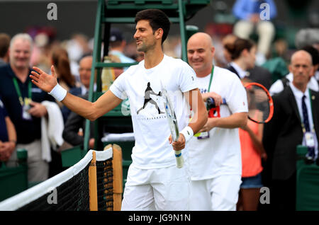 Novak Djokovic practice guardato in pullman Andre Agassi del giorno due dei campionati di Wimbledon al All England Lawn Tennis e Croquet Club, Wimbledon. Foto Stock