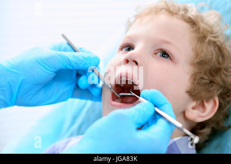 Close up boy avente i suoi denti esaminati da un dentista Foto Stock