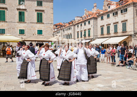 Croazia Dubrovnik Croazia costa dalmata turisti gente locale ballo folk in costume nazionale piazza della città vecchia di Dubrovnik Città vecchia Dubrovnik Croazia Foto Stock