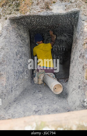 L'uomo carving rock per un tradizionale luogo di sepoltura nella Tana Toraja, Sulawesi Indonesia Foto Stock