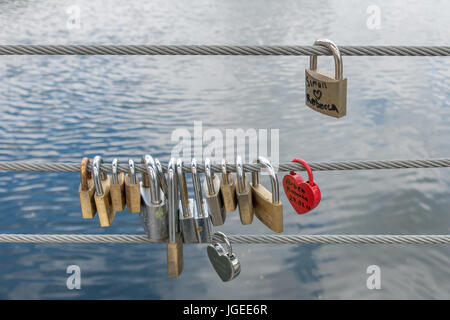 Lucchetti sul lato di un ponte, fili di sicurezza Foto Stock