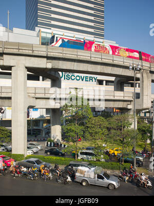 BTS Skytrain in cemento armato viadotto con il traffico stradale allo svincolo di seguito. Bangkok, Thailandia Foto Stock