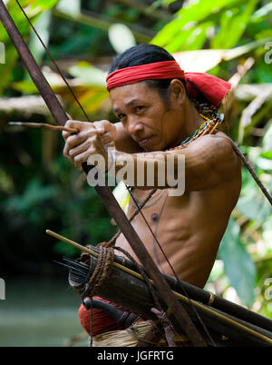 MENTAWAI persone, a ovest di Sumatra, SIBERUT ISOLA, Indonesia - 03 OKTOBER 2011: uomo hunter Mentawai tribù con arco e frecce nella giungla. Foto Stock