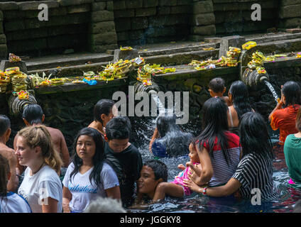 Adoratori di prendere un bagno nella piscina di depurazione a Tirta Empul temple, isola di Bali, Tampaksiring, Indonesia Foto Stock