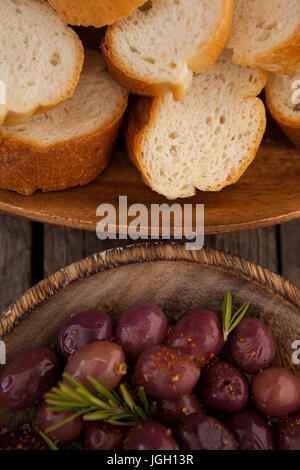 Vista aerea di olive e pane in piastre su tavola Foto Stock