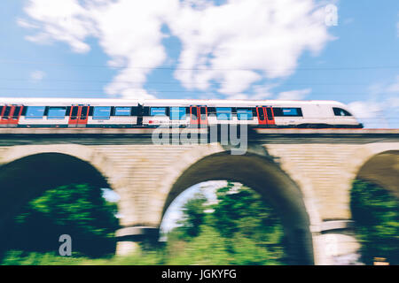 Ginevra, Svizzera - 25 Giugno 2017: Swiss treno regionale che passa al di sopra di un ponte nel Cantone di Ginevra regione, con motion blur. Foto Stock