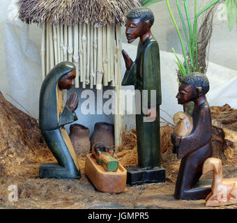 Presepe con la santa famiglia dall Angola in stile africano con un capanno in background Foto Stock